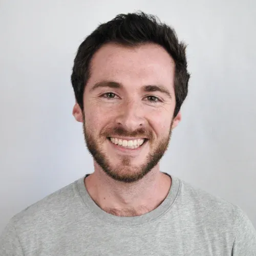 Benjamin Shanahan, wearing a gray shirt and smiling at the camera